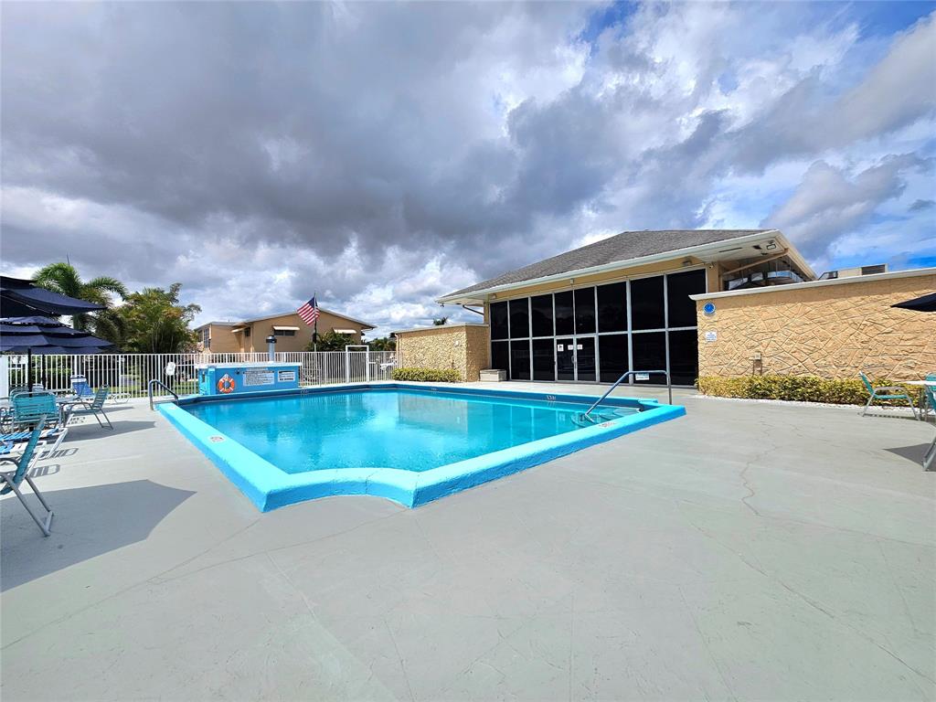 2141 Northeast 1st Court, Unit 201 Boynton Beach, FL 33435 - Photo 26 of 26 a view of a house with swimming pool and sitting area