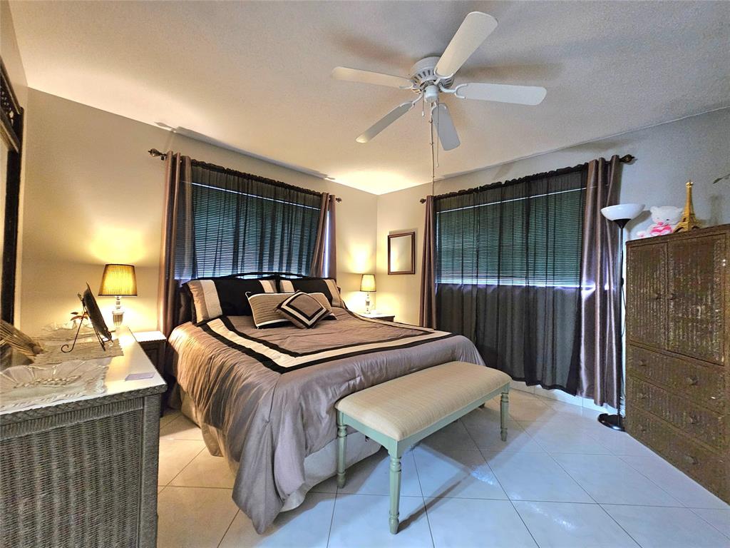 2141 Northeast 1st Court, Unit 201 Boynton Beach, FL 33435 - Photo 8 of 26 a bedroom with a bed and a dresser