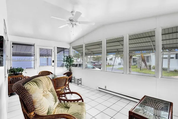 a living room with furniture and floor to ceiling windows