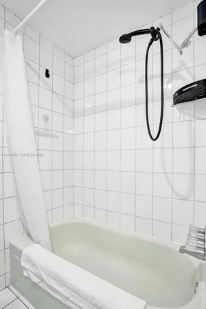 a bathroom with a bath tub with a shower