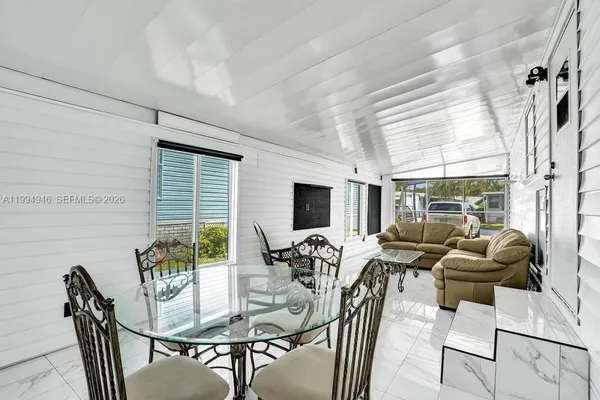a view of a dining room with furniture window and outside view