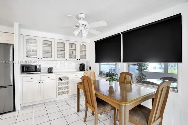 a kitchen with stainless steel appliances a microwave a stove and white cabinets