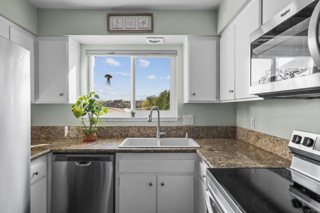 3757 Dearborn Street Oceanside, CA 92057 - Photo 16 of 33 a kitchen with stainless steel appliances granite countertop a sink and cabinets