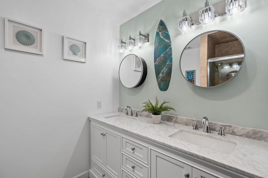 3757 Dearborn Street Oceanside, CA 92057 - Photo 24 of 33 a bathroom with a double vanity sink and a mirror