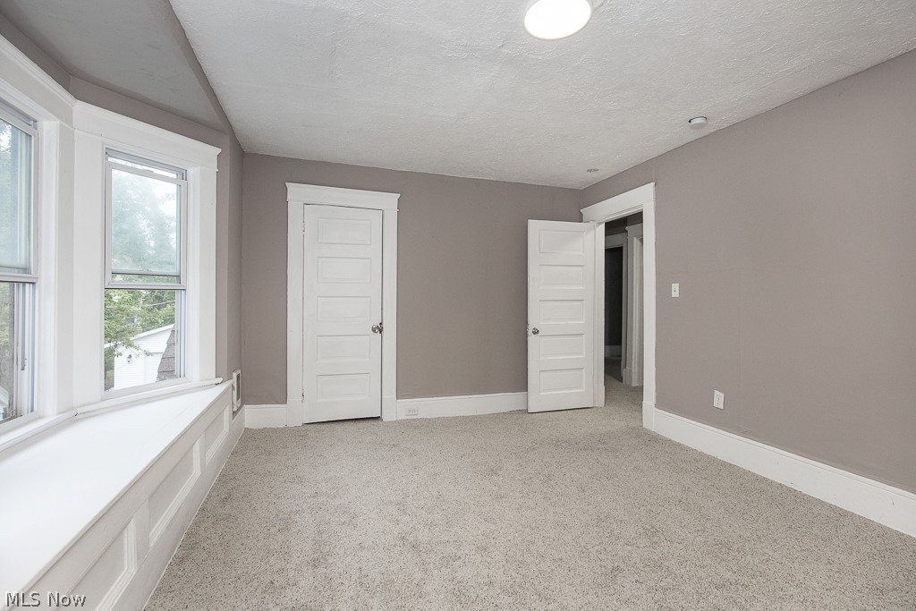 1892 Beersford Road Cleveland, OH 44112 - Photo 25 of 47 Unfurnished bedroom with a textured ceiling and light carpet