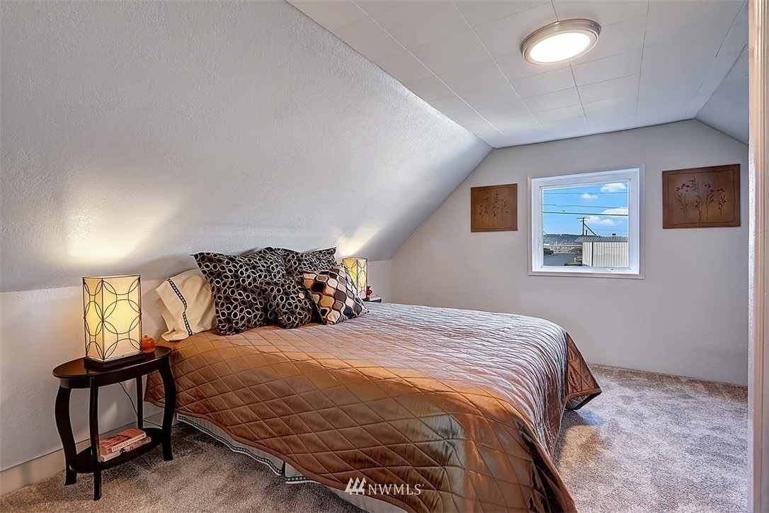 105 South Tobin Street Renton, WA 98057 - Photo 8 of 20 a bedroom with a bed and wooden floor