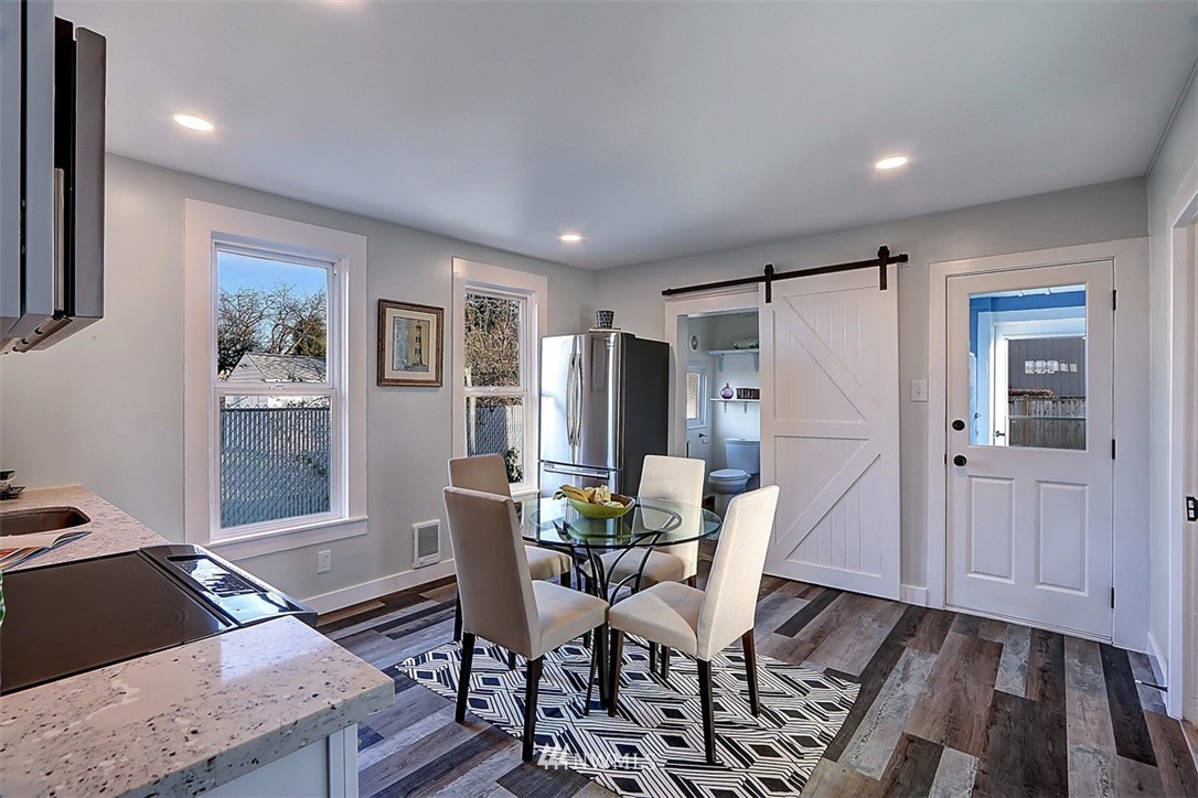 105 South Tobin Street Renton, WA 98057 - Photo 10 of 20 a view of a dining room with furniture window and wooden floor