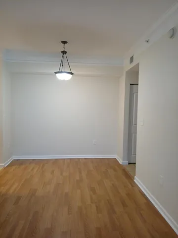 a view of a room with wooden floor and white walls