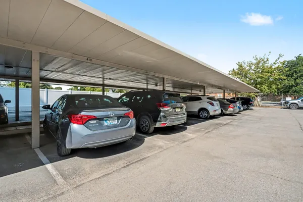 a view of parking garage with cars parked