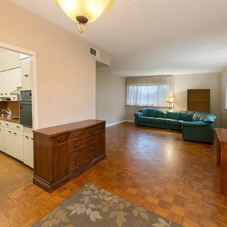 a kitchen with granite countertop a refrigerator and a stove top oven