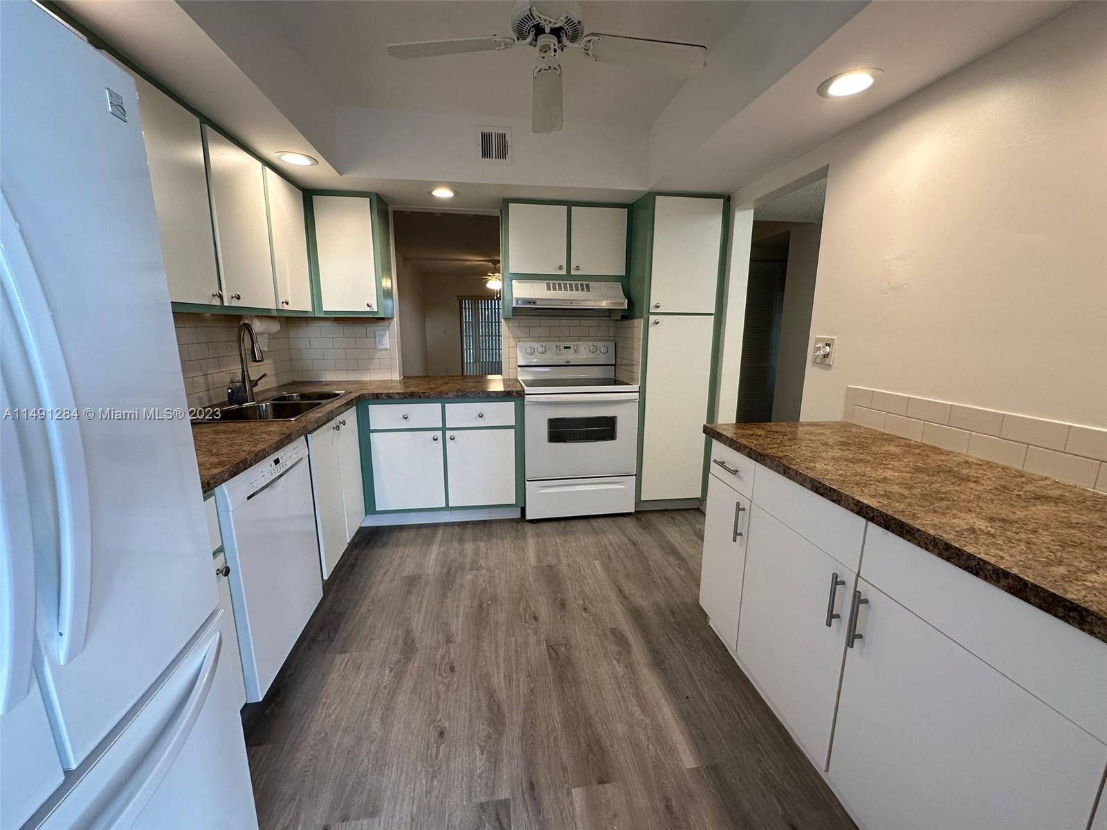 Arrowhead Condominium Davie, FL 33324 - Photo 11 of 23 a kitchen with granite countertop a sink and steel appliances