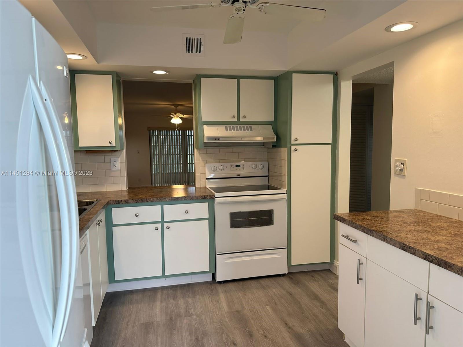 Arrowhead Condominium Davie, FL 33324 - Photo 12 of 23 a kitchen with cabinets stainless steel appliances and a counter space