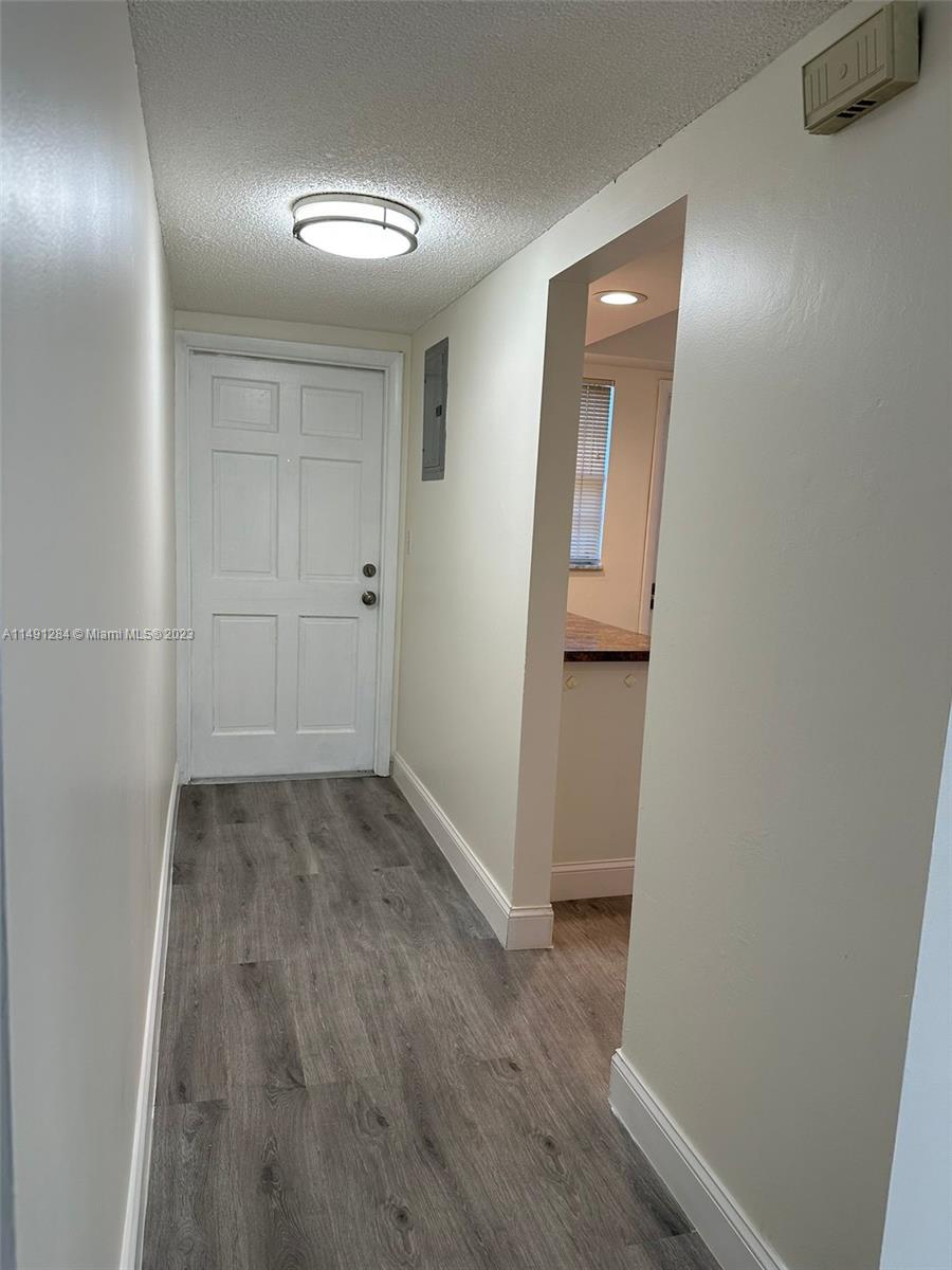Arrowhead Condominium Davie, FL 33324 - Photo 15 of 23 a view of a hallway with wooden floor
