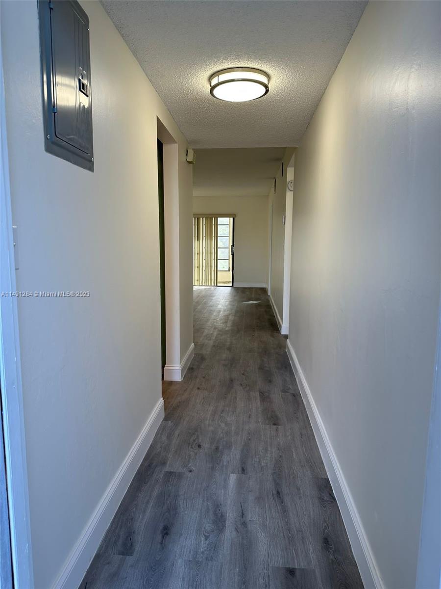 Arrowhead Condominium Davie, FL 33324 - Photo 17 of 23 a view of a hallway with wooden floor