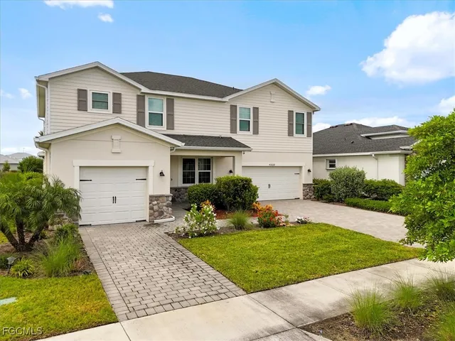 a front view of a house with a yard and garage