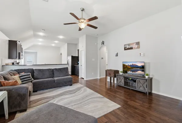 a living room with furniture and wooden floor