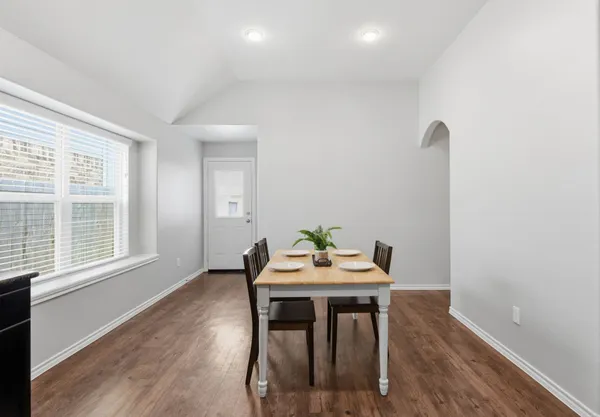 a view of a dining room with furniture and wooden floor