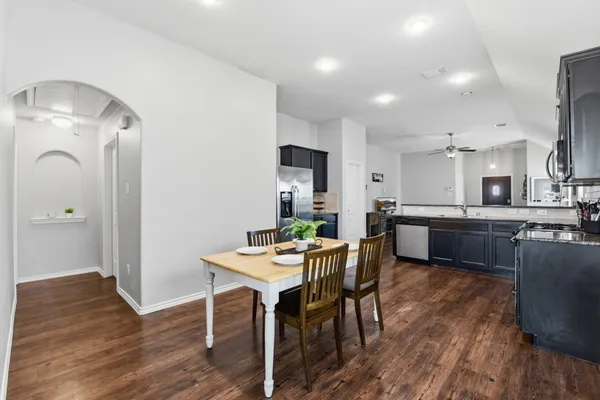 a view of a dining room with furniture and wooden floor