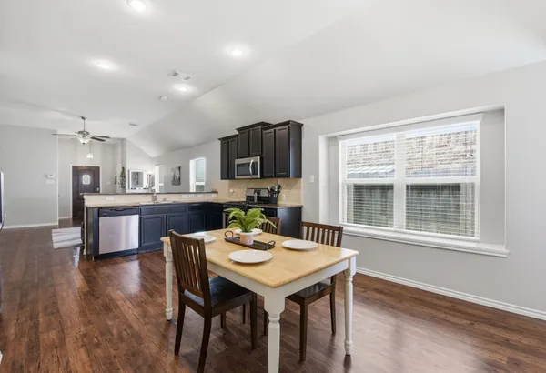 a kitchen with a table and chairs in it