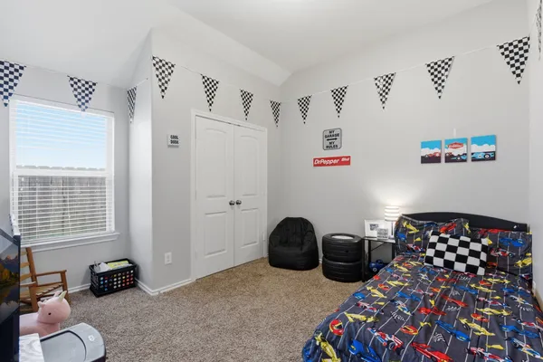 a bedroom with bed and a closet