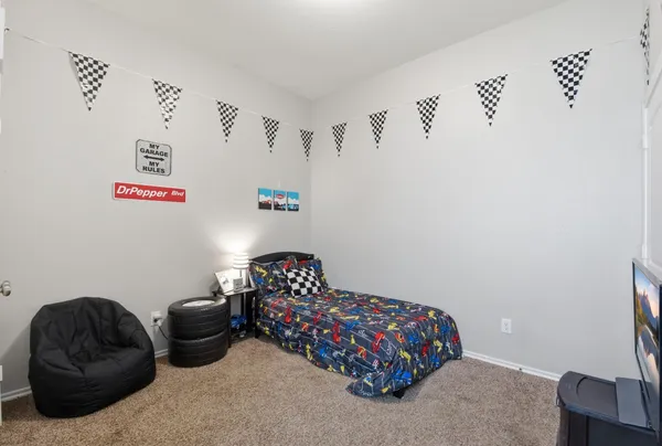 a bedroom with a bed and a chair