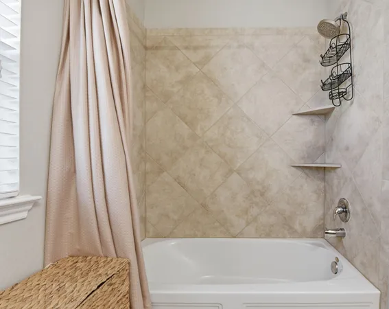 a bathroom with a tub and a shower curtain