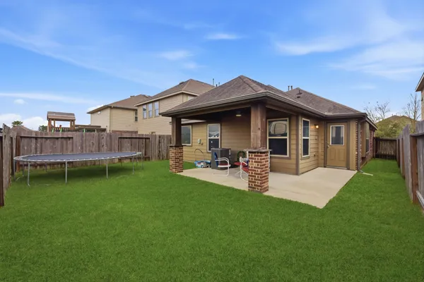 a view of a house with backyard and porch