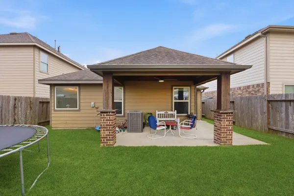 a view of a house with backyard sitting area and garden
