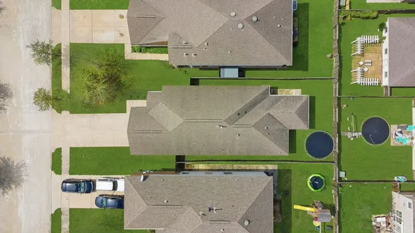an aerial view of house with a yard