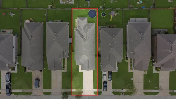 an aerial view of multiple house with outdoor space