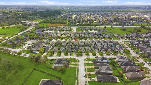 an aerial view of residential houses with outdoor space and river
