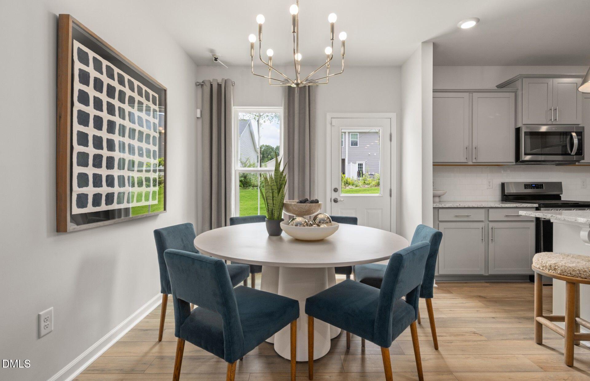 230 Broomside Avenue Raleigh, NC 27603 - Photo 15 of 25 a view of a dining room with furniture window and wooden floor