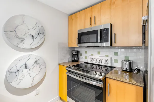 a kitchen with a stove and a microwave