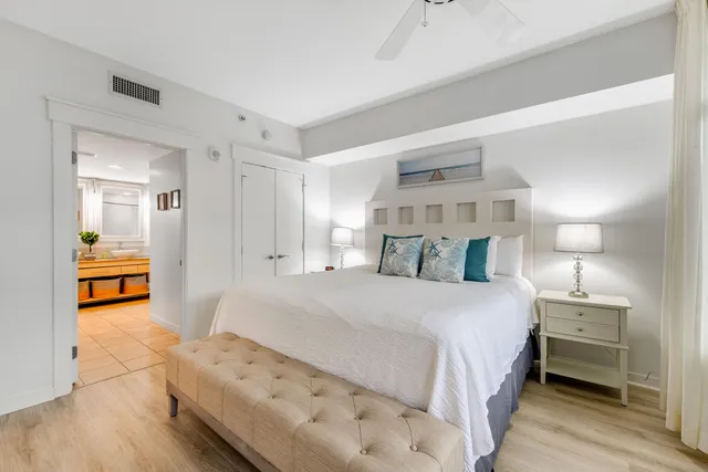 a bedroom with a bed and a view of kitchen
