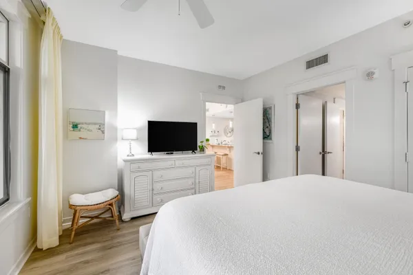 a bedroom with a bed and a flat screen tv