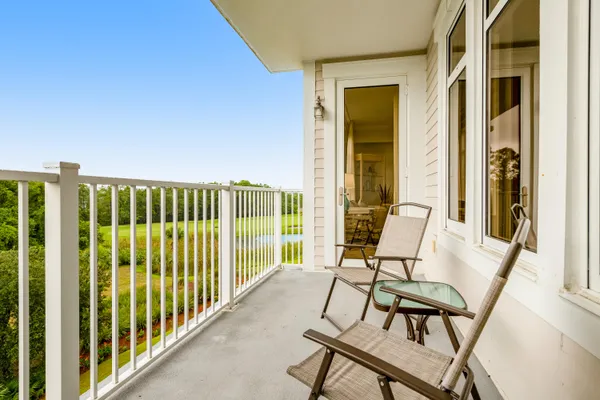 a view of a balcony with chairs