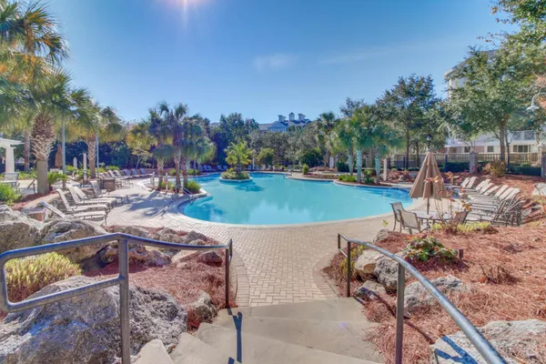 a view of a swimming pool and lounge chairs