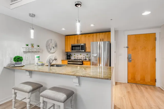 a kitchen with sink refrigerator and microwave
