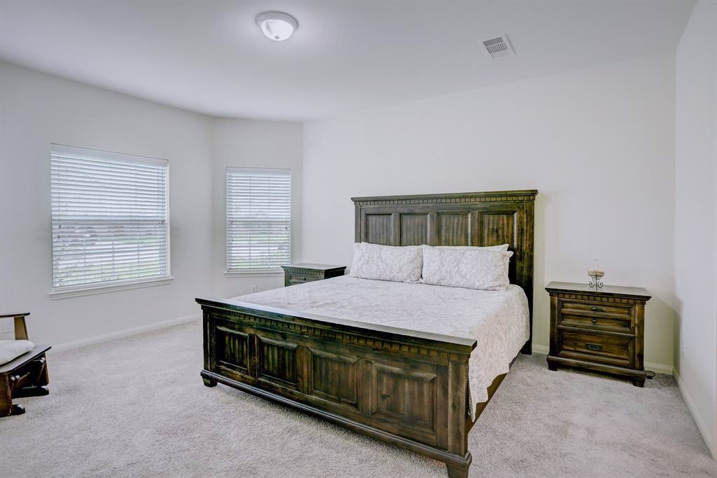 1303 Emerald Stone Drive Rosharon, TX 77583 - Photo 11 of 25 Luxurious primary suite offering generous space, peaceful comfort, and an abundance of natural light.