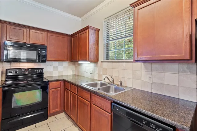 a kitchen with stainless steel appliances granite countertop a sink and a granite counter tops