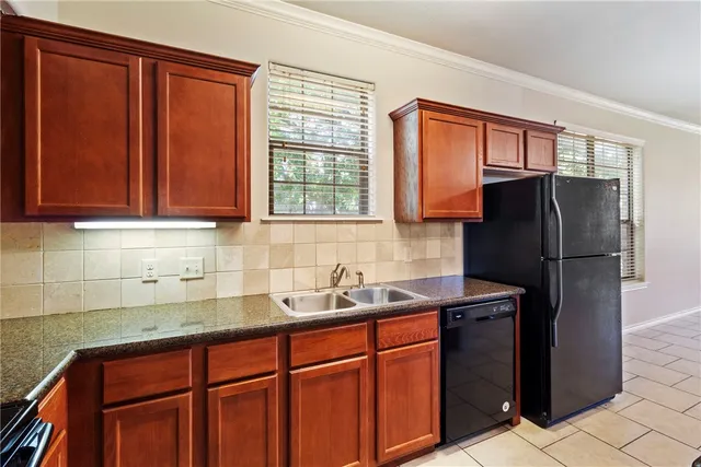 a kitchen with stainless steel appliances granite countertop a sink a stove a microwave and cabinets