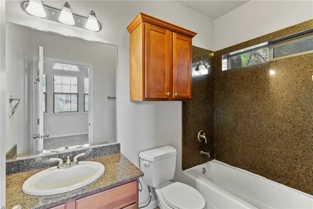 an empty room with closet and a ceiling fan