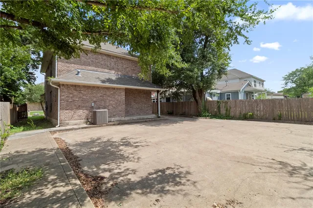 a backyard of a house with plants and trees