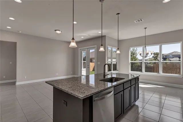 a kitchen with granite countertop a sink and a counter top space