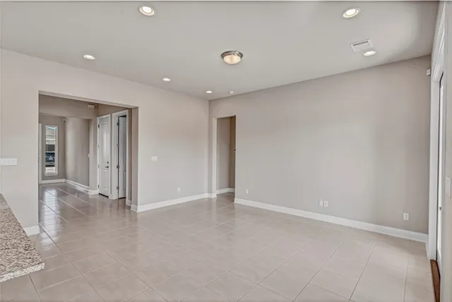 a bathroom with a granite countertop sink a light fixture and a mirror