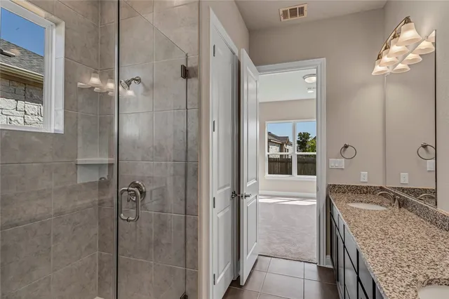 an empty room with a window and chandelier