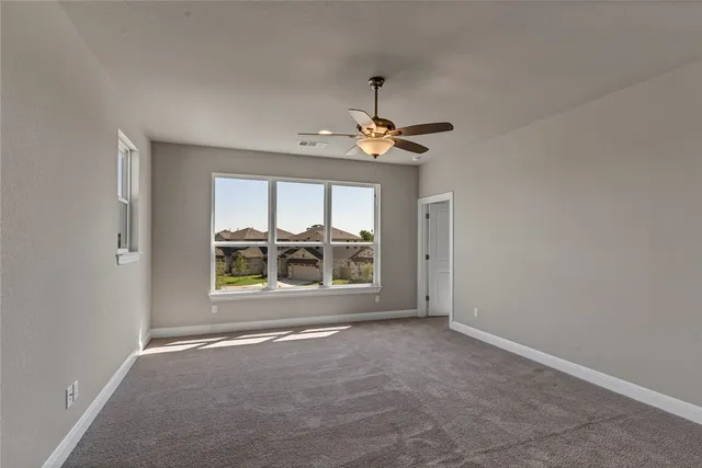 a bathroom with a granite countertop sink a toilet and shower