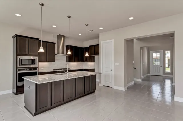 a kitchen with stainless steel appliances granite countertop a stove and a sink