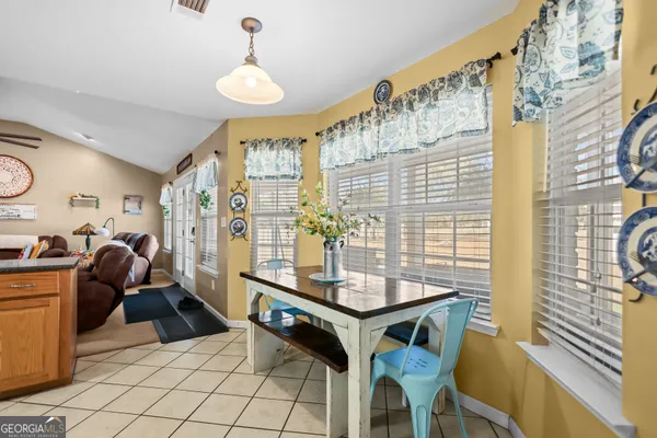 a view of a dining room with furniture and chandelier
