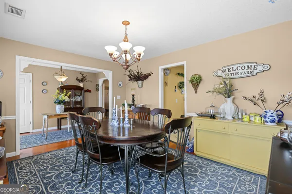a view of a dining room with furniture and chandelier